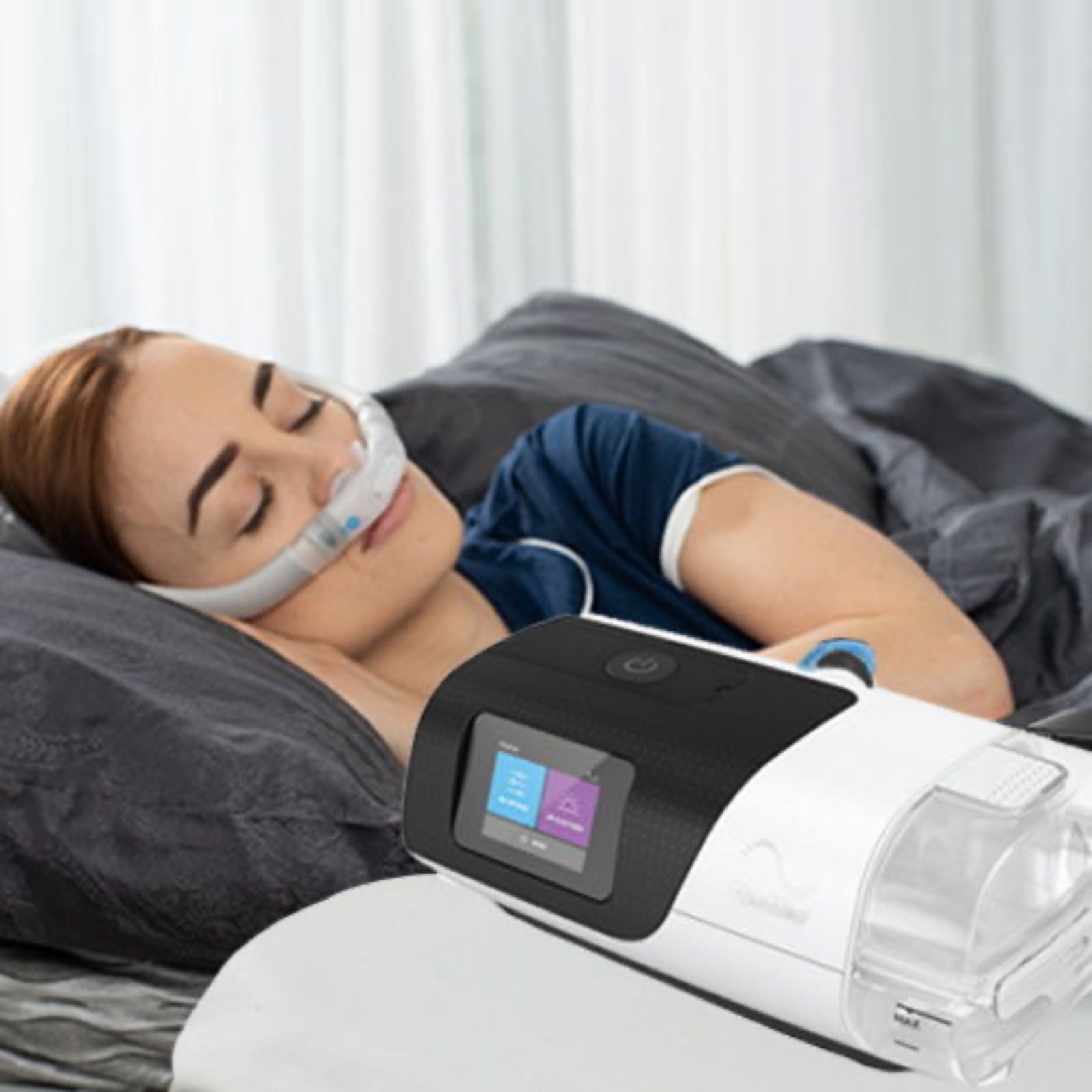 Woman sleeping with a ResMed AirSense 11 on the nightstand