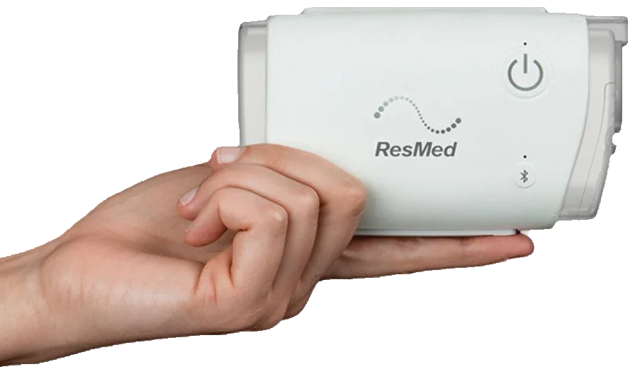 ResMed AirMini held in a hand